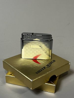 un briquet posé sur une boîte dorée