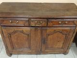 a wooden cabinet with two drawers on top of it