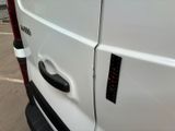 a close up of a white van with a black door handle