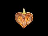 a close up of a heart shaped pendant on a black background