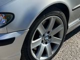 a silver car that is parked on the side of the road