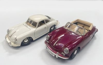 two toy cars sitting next to each other on a white surface