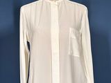 an image of a white shirt on a mannequin stand