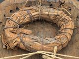 a wooden plaque with a wreath on top of it