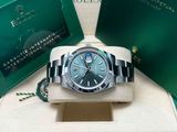 a close up of a rolex watch in a green box