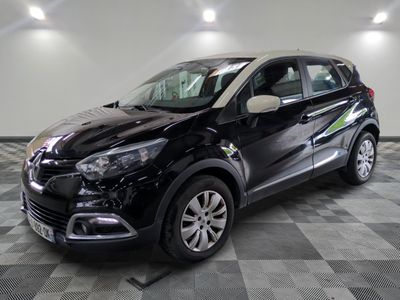 the black car is parked on a checkered floor in the garage