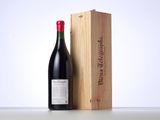 a bottle of wine sitting next to a wooden box
