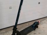 a scooter that is parked in front of a garage door