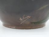 a black bowl with writing on it sitting on a table