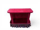 pink velvet box with tassels on a white background