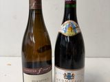 two bottles of wine sitting next to each other on a table