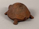 a small turtle that is sitting on a table