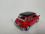 a small red car with a black top on a white surface