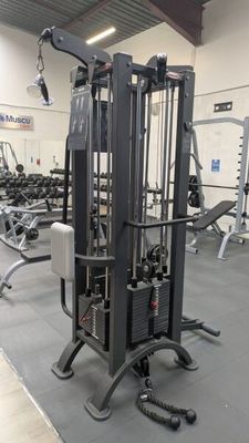 a gym with a lot of machines in the room