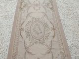 an image of a long rug on a floor with a cat on it