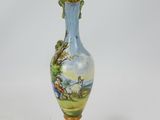 a blue and yellow vase with a painting on it