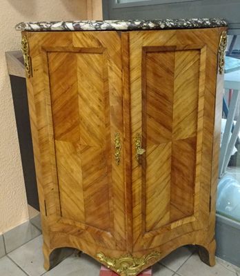 a wooden cabinet with a marble top in a room