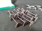 a lot of silver metal screws on a table