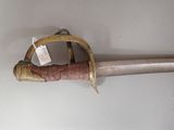 a very old sword that is hanging on the wall