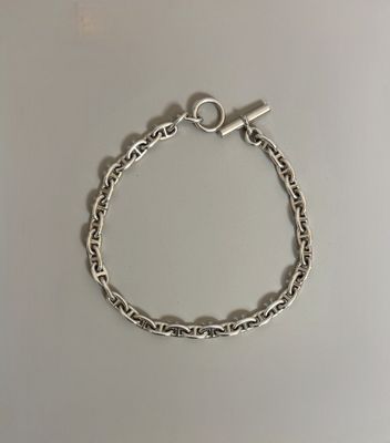 a silver bracelet with a heart charm on it