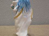 a figurine of a woman holding a baby on a horse