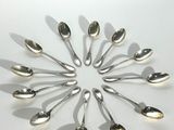 many spoons arranged in a circle on a table