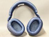 a pair of blue headphones sitting on top of a white surface