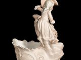 a figurine of a woman sitting on a boat