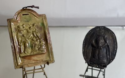 two metal objects that are on display in a glass case