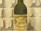 une bouteille de vin posée sur une table à côté d'une boîte à œufs