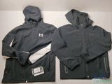 two men ' s under armour jackets with hoods on top of them