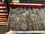 un tiroir rempli de vis et des vis dans un magasin