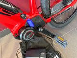 a close up of a red bicycle with a blue handlebar