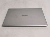a laptop that is sitting on a white surface