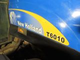 a close up of a blue and yellow train on the tracks