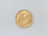 a close up of a gold coin on a white surface