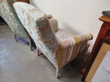 two chairs that are sitting next to each other in a room