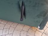 a green couch that has a zipper on it