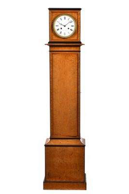 une grande horloge en bois posée sur un socle, avec un cadran blanc