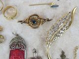 many different types of jewelry laying on a table