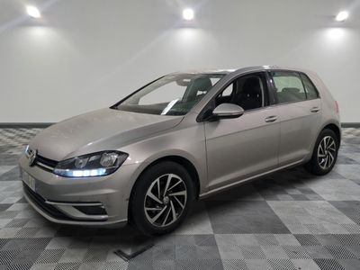 the volkswagen golf is parked in a clean room with a checkered floor