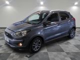 a grey ford kad is parked in a room with a checkered floor