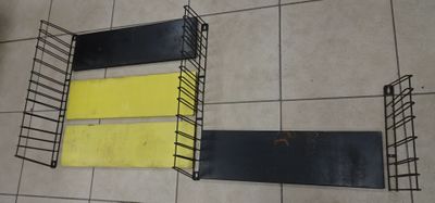 two shelves that have yellow and black strips on them