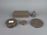 a group of silver objects including a box, a candle, and a lighter