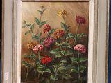 an oil painting of flowers in a white frame on a blue wall