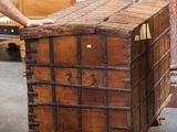 a man standing next to a wooden box in a warehouse