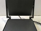 a close up of an electric grill on a counter top