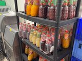 many bottles of juice on the shelves in the kitchen