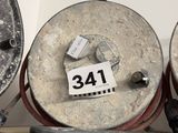 three old metal drums sitting on a shelf in a room
