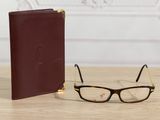glasses and a book sitting on a table next to each other